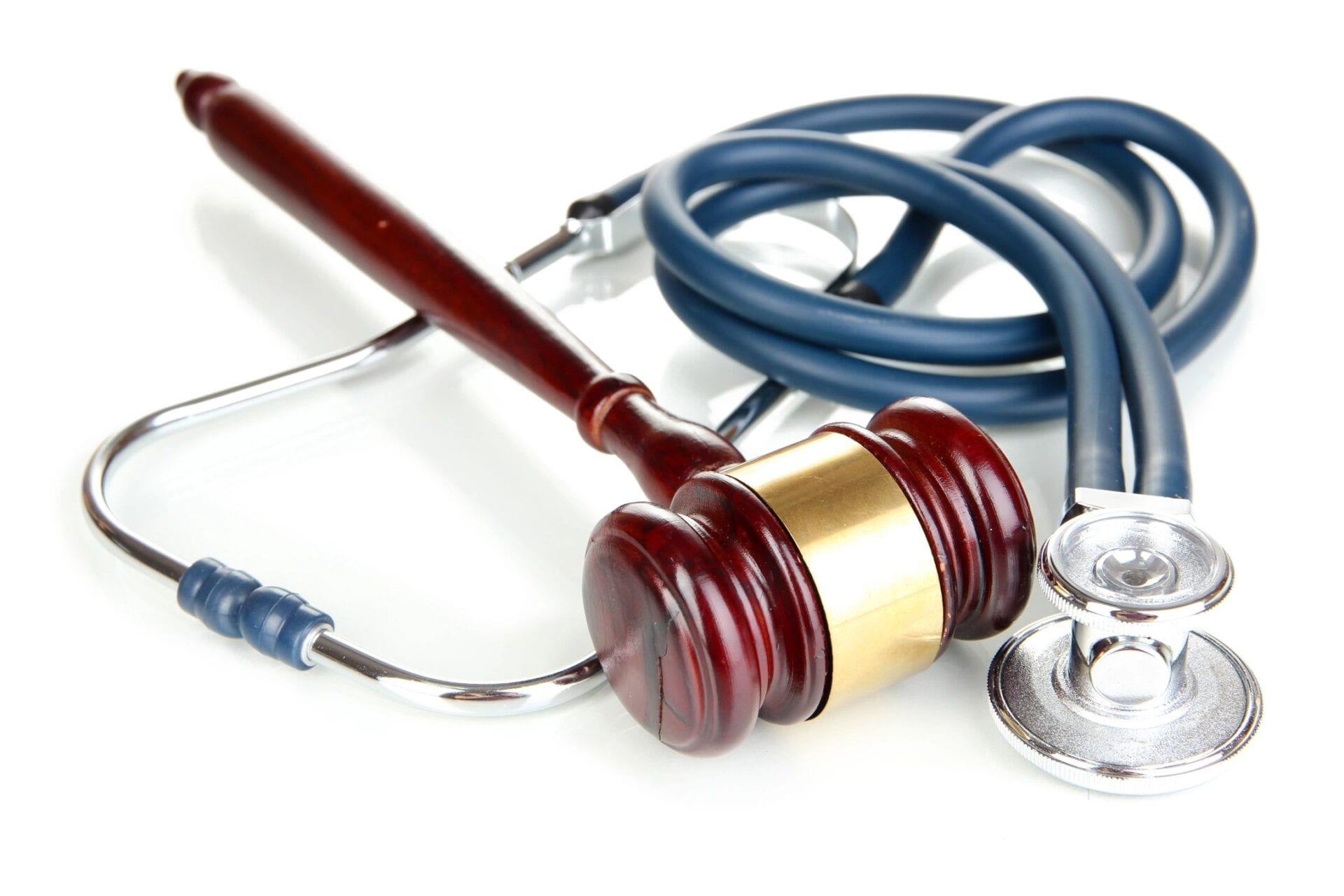 A judge 's gavel and stethoscope are on the table.