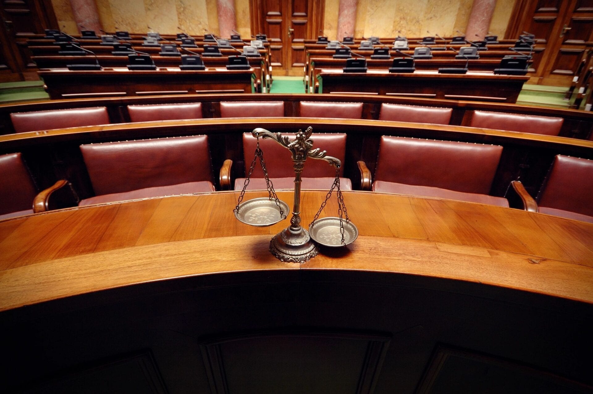 A courtroom with two judges chairs and a table.